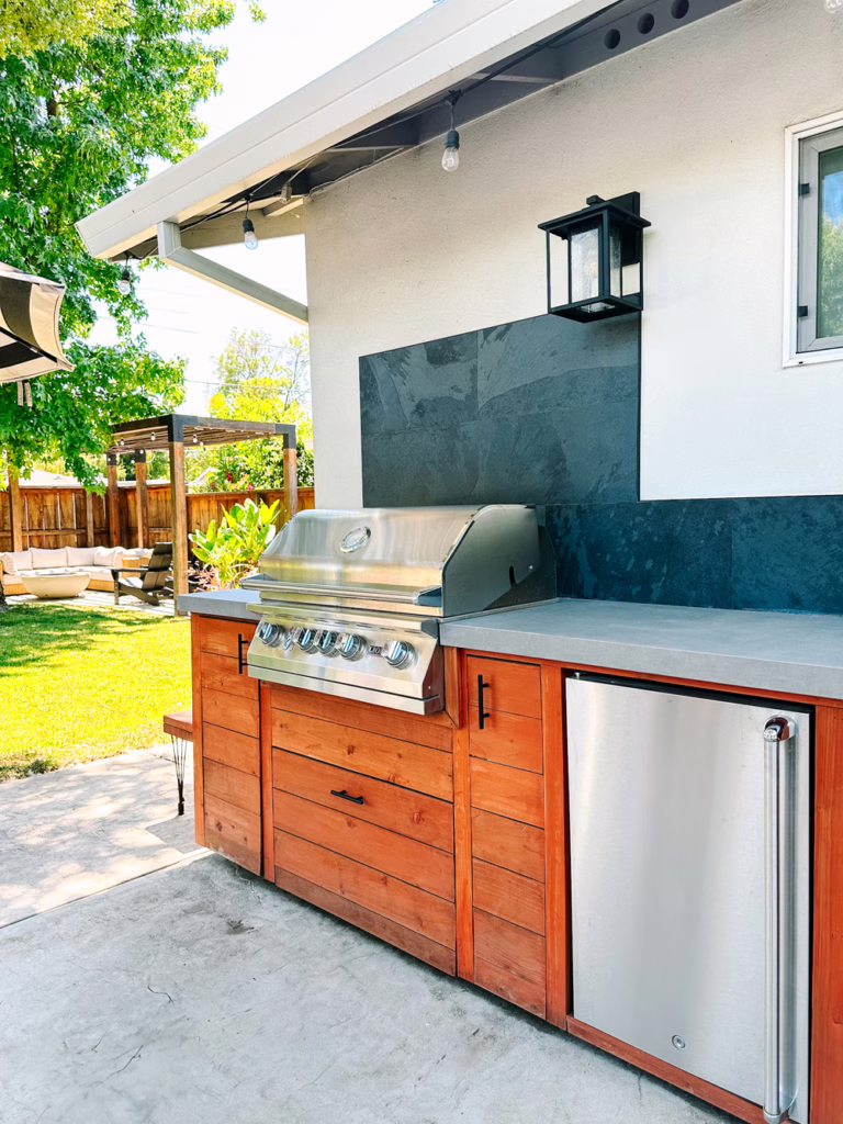 outdoor kitchen with black tile backsplash