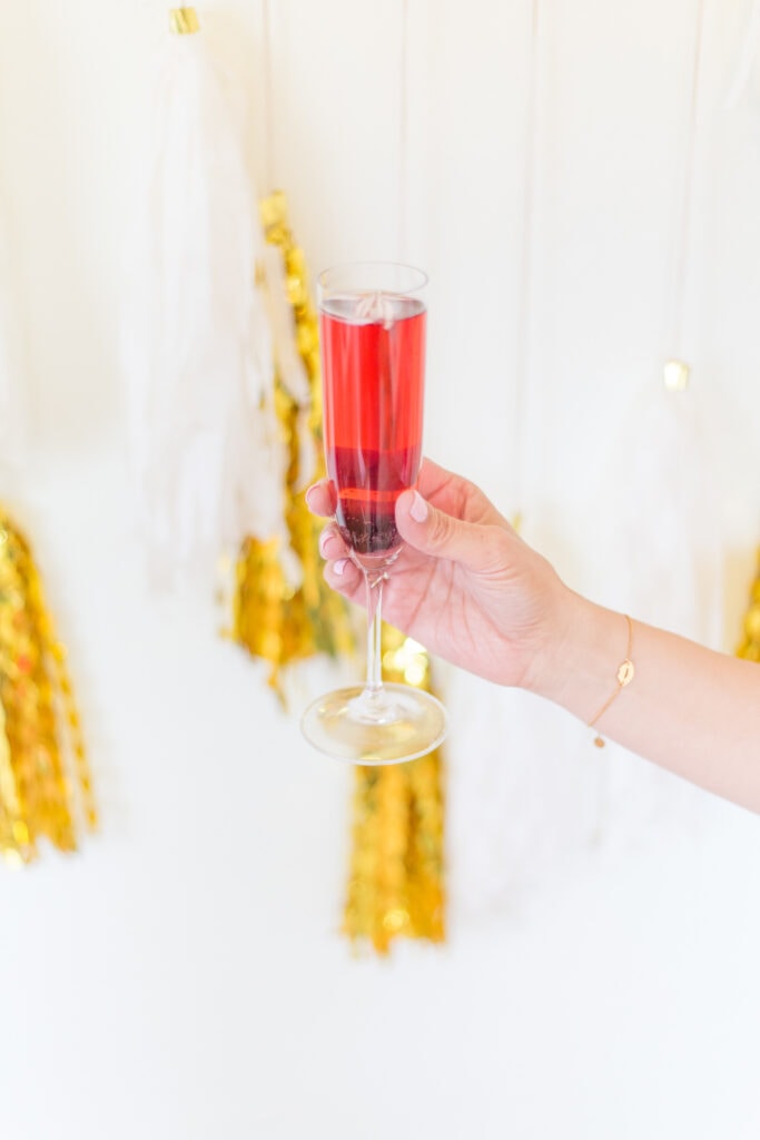 hand holding a kir royale cocktail