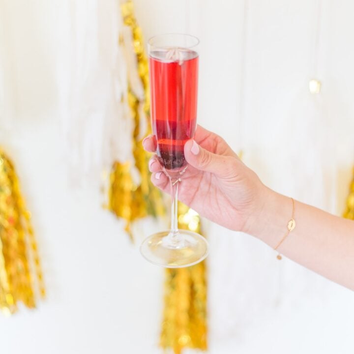 hand holding a kir royale cocktail