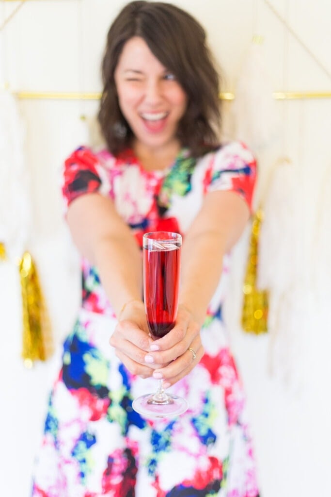 woman holding a kir royale cocktail