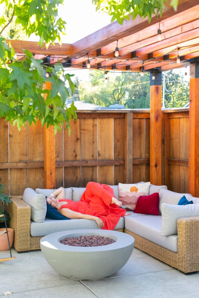 laying on outdoor couch under pergola