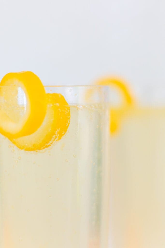 French 75 cocktail close up with lemon twist