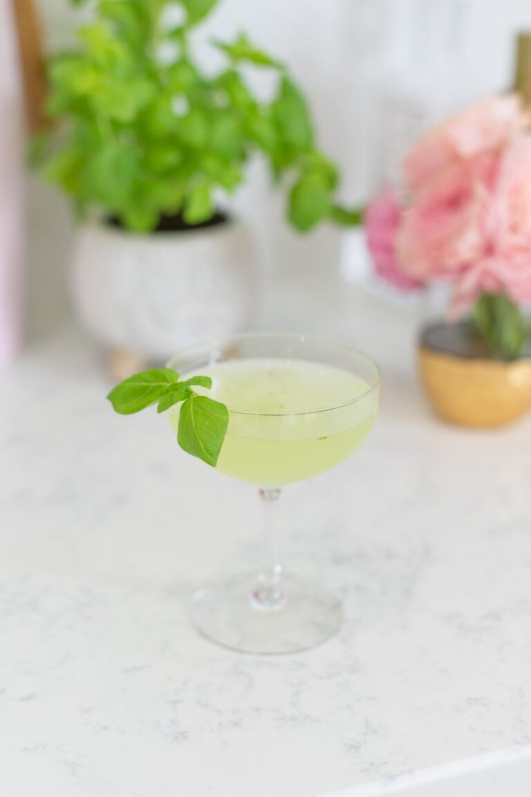cocktail with basil garnish