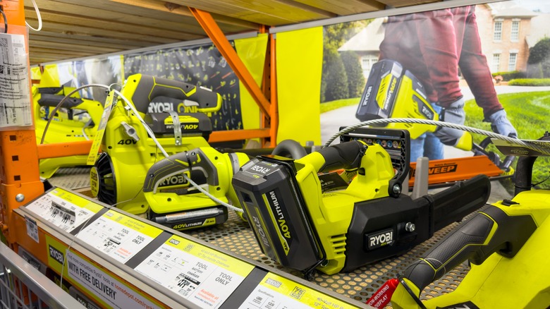 Retail display of various green Ryobi brand tools
