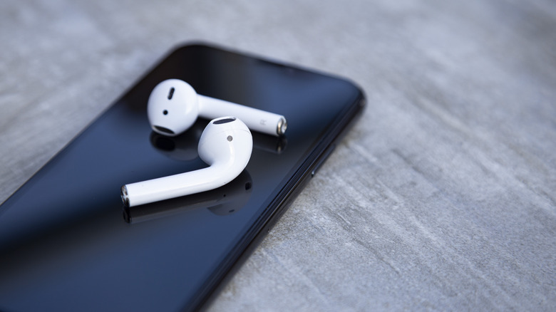 AirPods sitting on top of iPhone