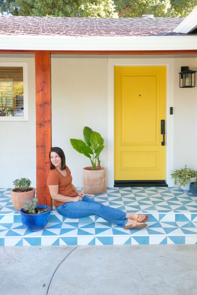 woman sitting on front porch with wrapped posts